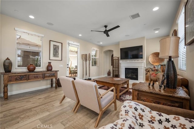 living room with ceiling fan, a healthy amount of sunlight, and light hardwood / wood-style floors