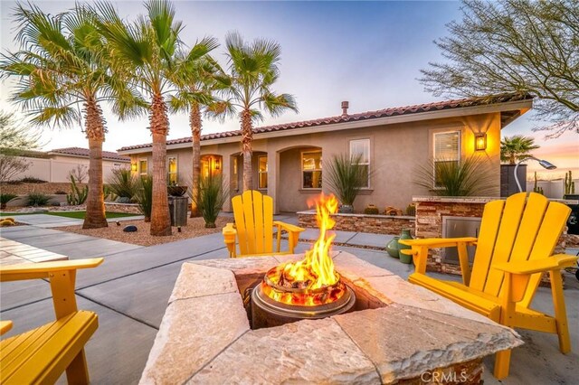 patio terrace at dusk with a fire pit