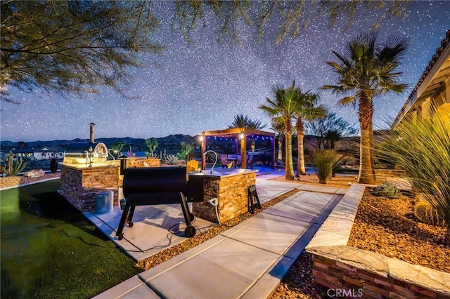 exterior space featuring a gazebo, a mountain view, and a bar