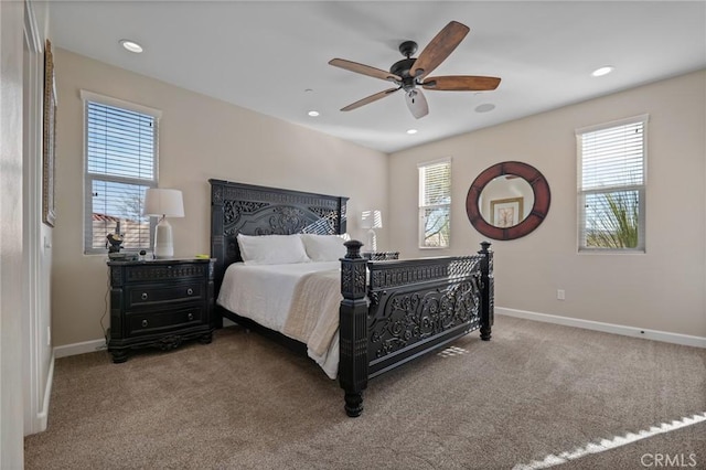 bedroom featuring ceiling fan, multiple windows, and carpet flooring