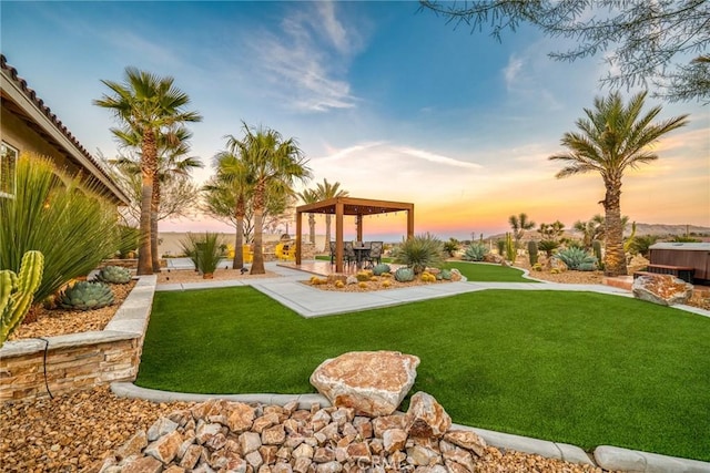 yard at dusk featuring a patio