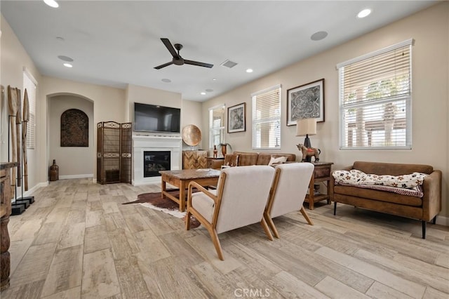 living room with light wood-type flooring and ceiling fan