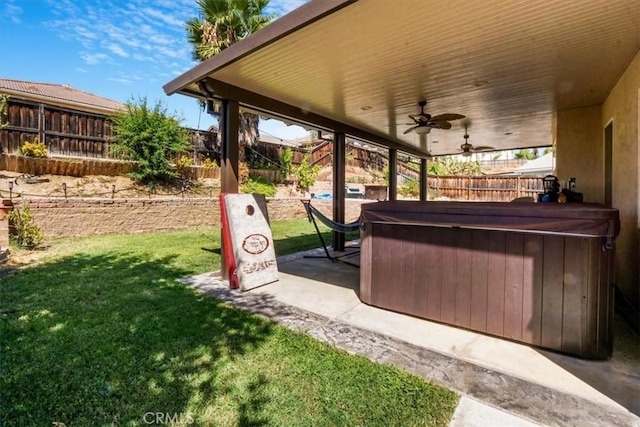 view of yard featuring ceiling fan, a patio area, and a hot tub