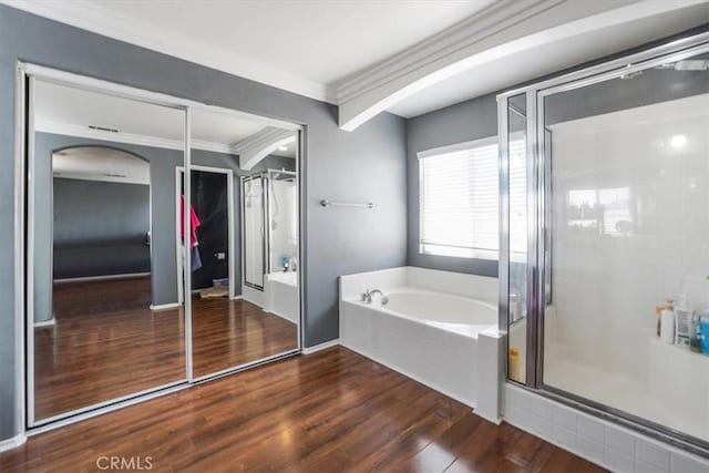 bathroom with independent shower and bath, crown molding, and wood-type flooring