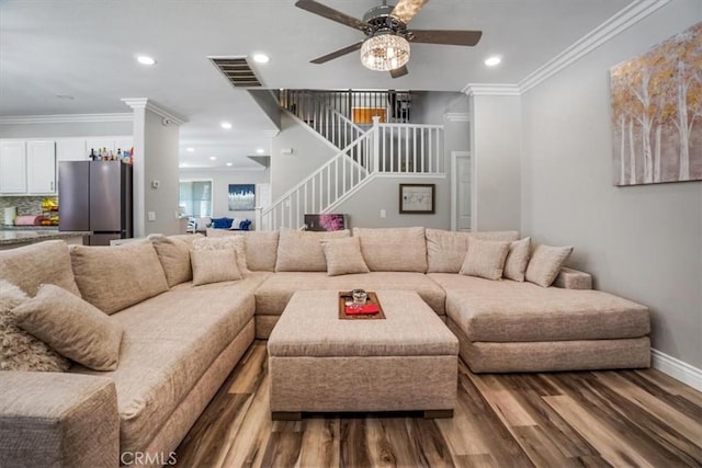 living room featuring ceiling fan, crown molding, and hardwood / wood-style floors