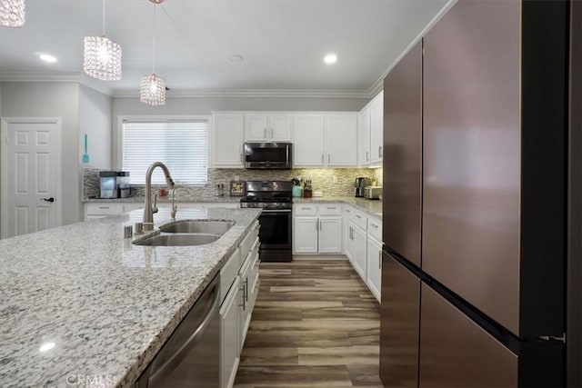 kitchen with sink, an inviting chandelier, hanging light fixtures, stainless steel appliances, and white cabinets