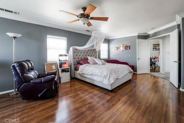 bedroom with ceiling fan, dark wood-type flooring, and ornamental molding