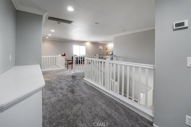 hall featuring crown molding and dark carpet