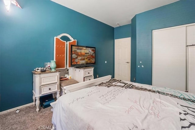 bedroom with carpet and a closet