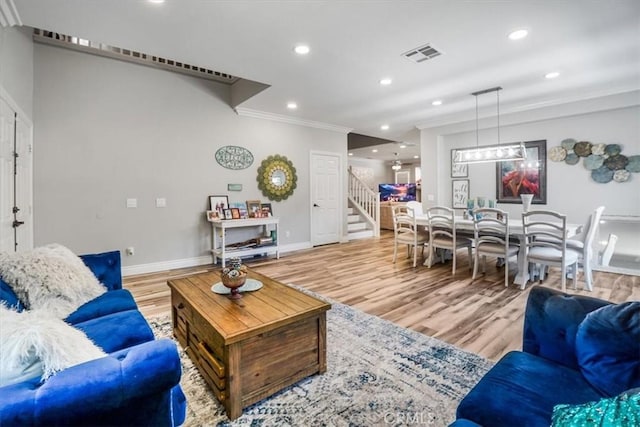 living room featuring crown molding and hardwood / wood-style floors