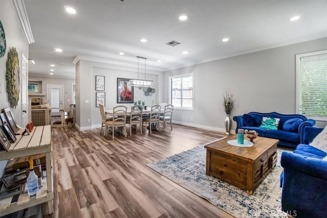 living room featuring wood-type flooring and ornamental molding