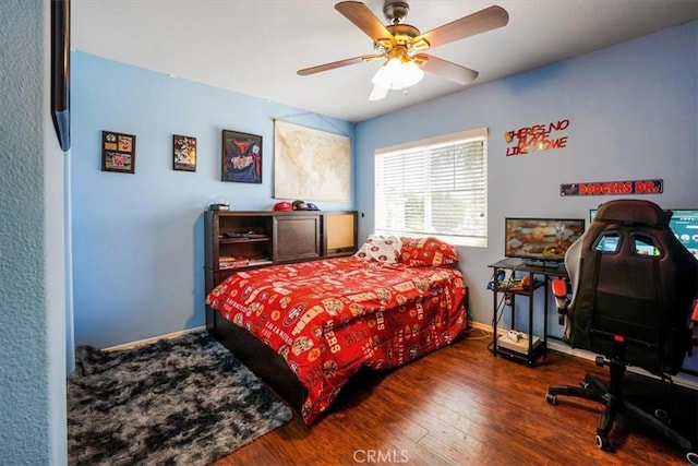 bedroom featuring ceiling fan and dark wood-type flooring