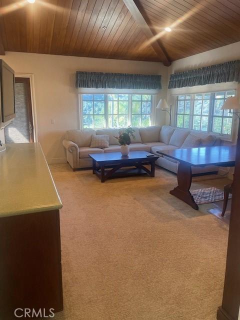 carpeted living room with vaulted ceiling and wooden ceiling