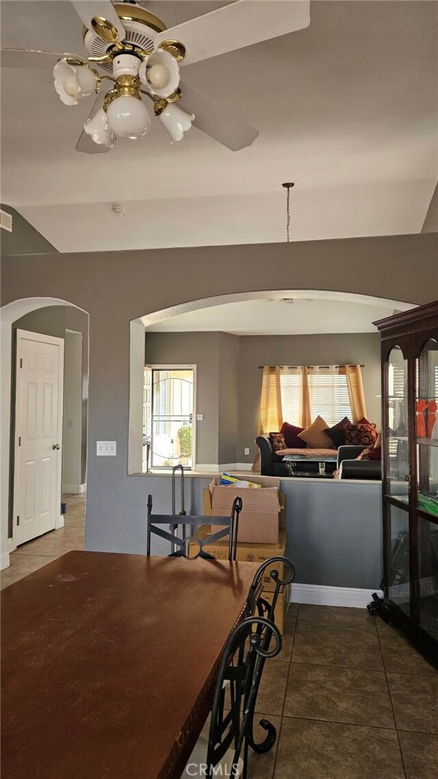 tiled dining area with ceiling fan and plenty of natural light