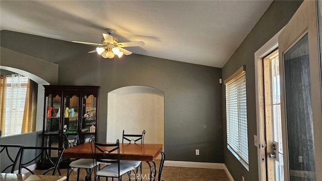 tiled dining space with lofted ceiling and ceiling fan