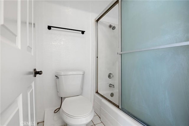 bathroom featuring toilet, tile patterned floors, and shower / bath combination with glass door