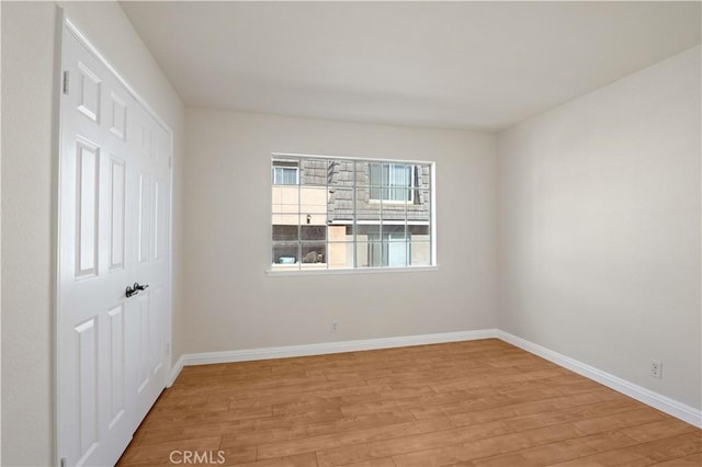 unfurnished room with light hardwood / wood-style flooring