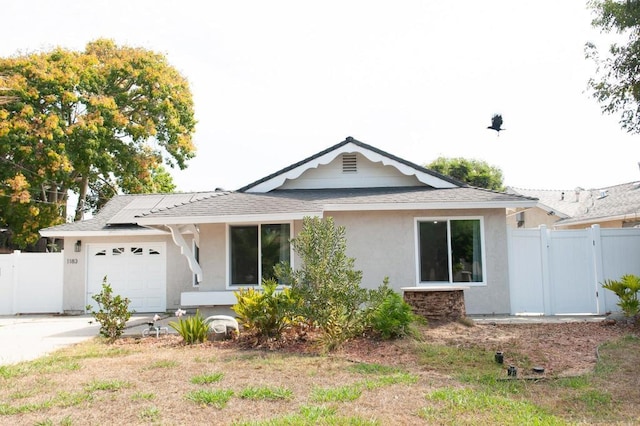 ranch-style house with a garage and solar panels