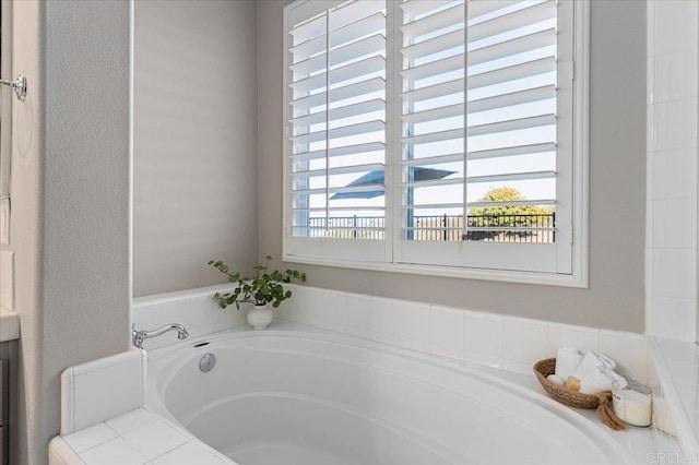 bathroom featuring tiled bath