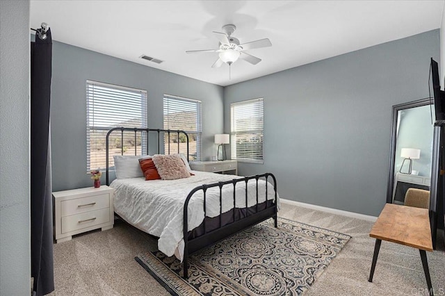 bedroom with ceiling fan and light colored carpet