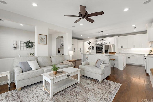 living room featuring ceiling fan and hardwood / wood-style flooring