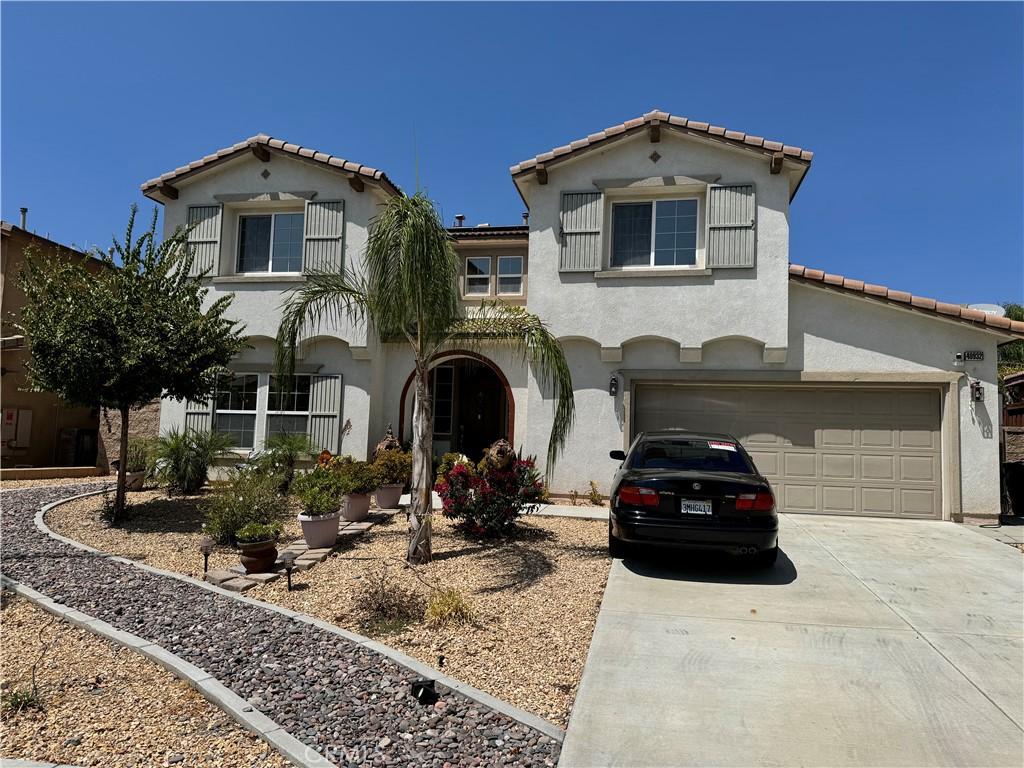 mediterranean / spanish house featuring a garage