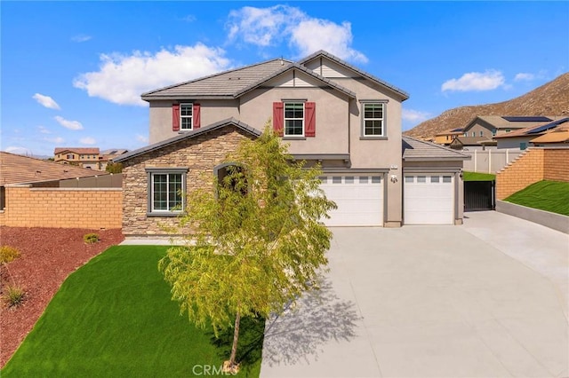 view of property featuring a front yard and a garage