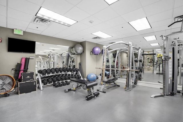 gym with a paneled ceiling