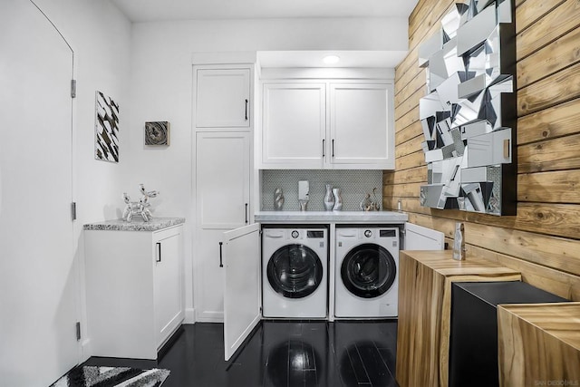 laundry area with washing machine and dryer and cabinets