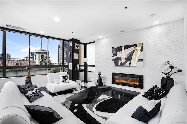 living room featuring wood-type flooring and a fireplace