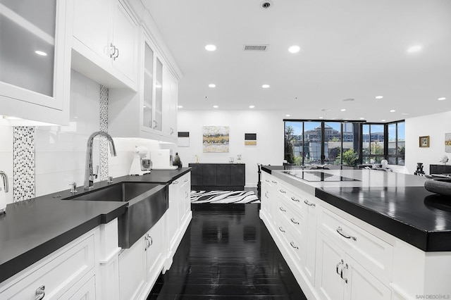 kitchen featuring white cabinetry, black electric cooktop, dark hardwood / wood-style floors, tasteful backsplash, and sink