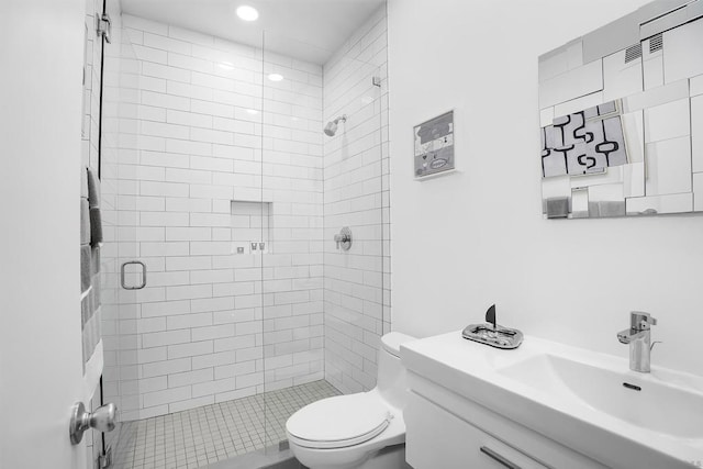 bathroom featuring toilet, sink, and a shower with shower door