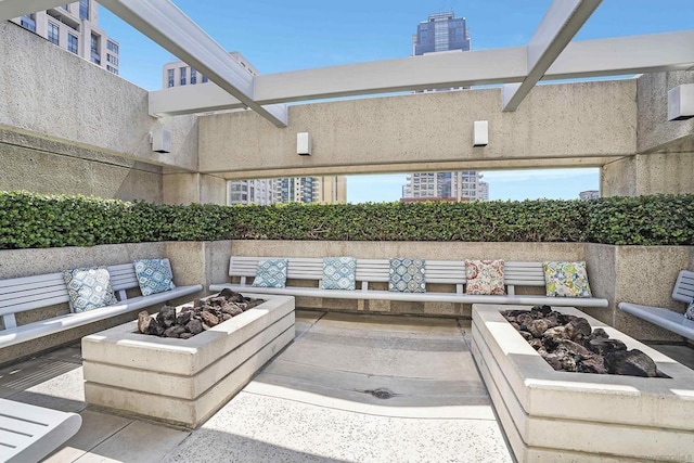 view of patio featuring an outdoor living space with a fire pit