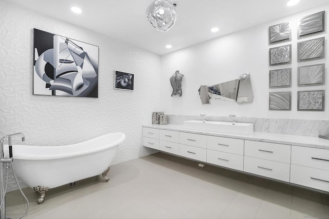 bathroom featuring a tub to relax in, vanity, and tile patterned flooring