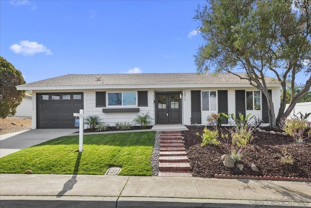 view of front of property with a garage and a front yard