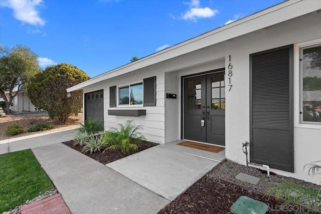 view of exterior entry with a garage