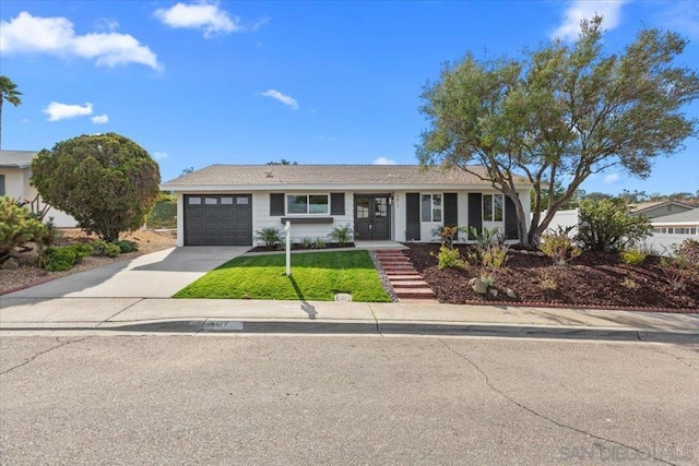 view of front of property with a front lawn and a garage