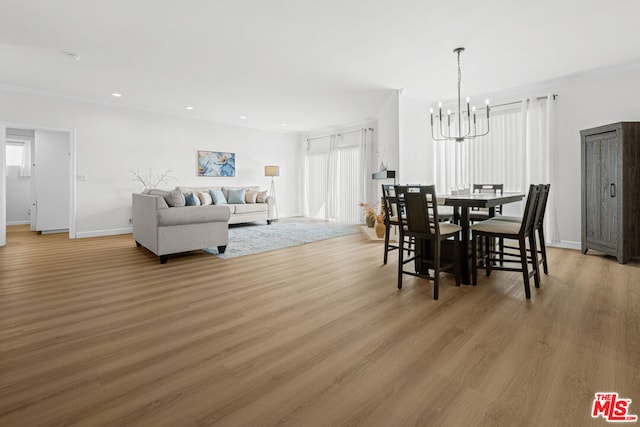 dining space with a chandelier, crown molding, and hardwood / wood-style floors