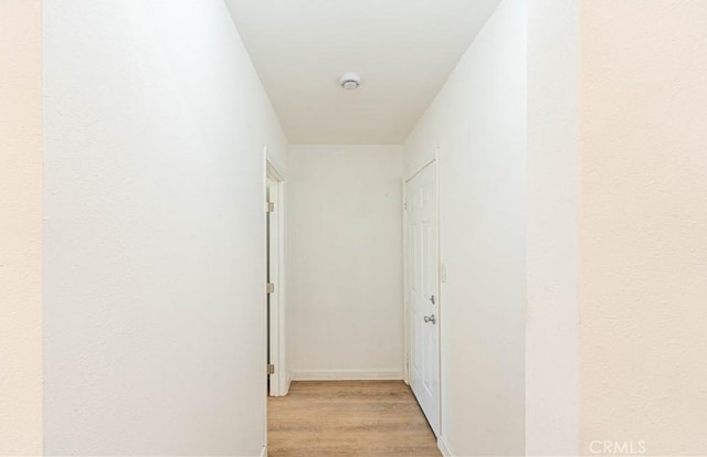 hallway with light hardwood / wood-style flooring