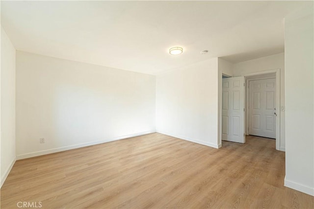 empty room with light hardwood / wood-style flooring