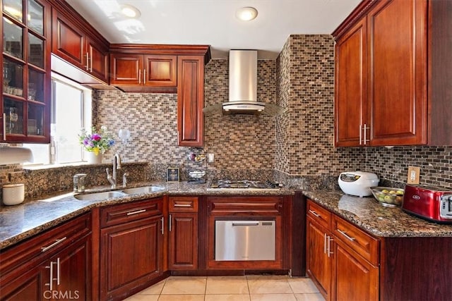 kitchen with backsplash, light tile patterned flooring, stainless steel gas cooktop, wall chimney range hood, and sink