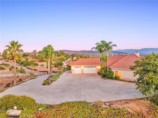 view of front of home with a garage and a mountain view