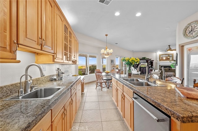 kitchen with light tile patterned floors, a kitchen island with sink, dishwasher, and sink