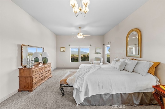 carpeted bedroom with ceiling fan with notable chandelier