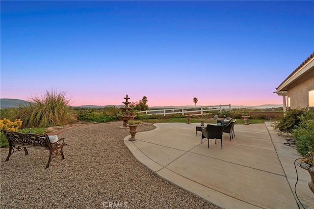 view of patio terrace at dusk