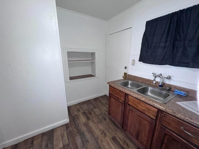 kitchen featuring sink, dark hardwood / wood-style floors, and built in shelves