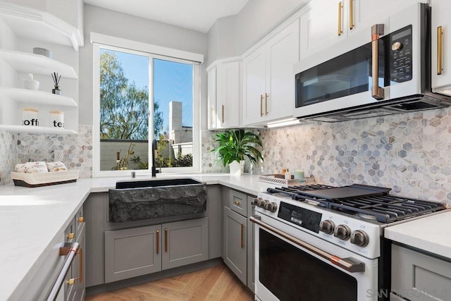 kitchen featuring sink, gray cabinetry, tasteful backsplash, white appliances, and white cabinets