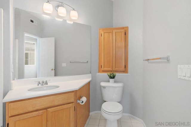 bathroom featuring vanity, tile patterned floors, and toilet