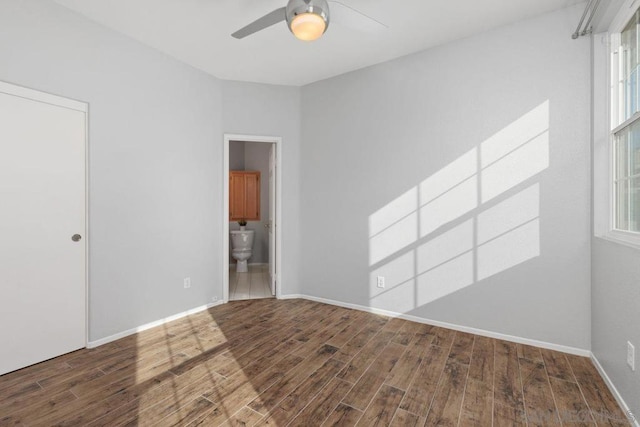 unfurnished room featuring dark wood-type flooring and ceiling fan