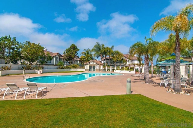 view of pool with a yard and a patio area